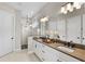 Bright main bathroom features dual sinks, quartz counters, modern shower, and sleek updated fixtures at 16049 Volterra Pt, Bella Collina, FL 34756