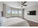 A main bedroom with natural light from the large windows, hardwood floors, and a ceiling fan at 16049 Volterra Pt, Bella Collina, FL 34756