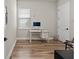This home office space is a functional and simple room with wood floors and natural light at 16049 Volterra Pt, Bella Collina, FL 34756