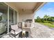 This covered patio features an outdoor kitchen and comfortable seating with a view at 16049 Volterra Pt, Bella Collina, FL 34756