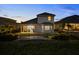 Charming rear exterior showcasing a covered patio with seating and a beautifully landscaped backyard at 16049 Volterra Pt, Bella Collina, FL 34756
