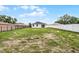 Spacious backyard surrounded by a white fence, providing a private outdoor space at 2211 Simmons St, Leesburg, FL 34748