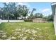 Large backyard surrounded by trees and fencing, offering privacy and plenty of room to enjoy outdoors at 2211 Simmons St, Leesburg, FL 34748