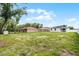 Expansive backyard offering plenty of space for outdoor activities, with fencing and mature trees at 2211 Simmons St, Leesburg, FL 34748