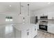 Modern kitchen featuring white cabinets, stainless steel appliances, and a center island at 2211 Simmons St, Leesburg, FL 34748