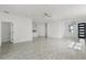 Open-concept living area featuring stylish gray flooring and abundant natural light at 2211 Simmons St, Leesburg, FL 34748