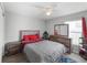 Bedroom featuring wood-look floors, a ceiling fan, and neutral decor for a serene and stylish space at 2461 Bulrush Dr, St Cloud, FL 34769