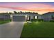 Well-maintained single-story home with manicured lawn, spacious driveway, and a two-car garage at 2461 Bulrush Dr, St Cloud, FL 34769