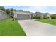 Charming single-story home features a well-manicured lawn and two-car garage at 2461 Bulrush Dr, St Cloud, FL 34769