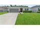 Attractive single-story home features lush green lawn and a convenient two-car garage at 2461 Bulrush Dr, St Cloud, FL 34769