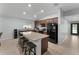 Spacious kitchen island with granite countertops, black appliances, and breakfast bar seating at 2461 Bulrush Dr, St Cloud, FL 34769