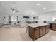 Open concept living room with kitchen island, modern lighting, and comfortable seating area at 2461 Bulrush Dr, St Cloud, FL 34769