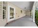 Covered back porch with white columns and neutral siding and trim at 2471 Jenscot Rd, St Cloud, FL 34771