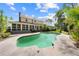 Expansive backyard featuring an in-ground pool, mature trees, and a charming home exterior at 2471 Jenscot Rd, St Cloud, FL 34771