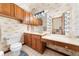Cozy bathroom featuring wallpaper, cabinets, and a vanity area with Hollywood style lighting at 2471 Jenscot Rd, St Cloud, FL 34771