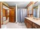 Bathroom features a shower and sink with traditional cabinets and colorful wallpaper at 2471 Jenscot Rd, St Cloud, FL 34771