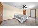 Bedroom with a queen-sized bed, ceiling fan, and adjacent bathroom at 2471 Jenscot Rd, St Cloud, FL 34771