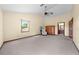 Open bedroom with two windows for natural light, chair, and entrance to ensuite bathroom at 2471 Jenscot Rd, St Cloud, FL 34771