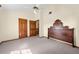 Bedroom featuring an antique headboard, access to hallway, and a ceiling fan at 2471 Jenscot Rd, St Cloud, FL 34771