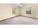 Serene bedroom bathed in natural light with two windows and neutral carpet at 2471 Jenscot Rd, St Cloud, FL 34771
