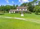 Charming two-story home with a sprawling lawn, a covered porch, and a long driveway at 2471 Jenscot Rd, St Cloud, FL 34771