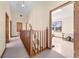 Bright hallway with views into a home office and other rooms, featuring neutral carpet and wood trim at 2471 Jenscot Rd, St Cloud, FL 34771