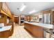 Spacious kitchen with tile flooring, wooden cabinetry, and stainless steel appliances at 2471 Jenscot Rd, St Cloud, FL 34771