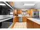 Well-equipped kitchen featuring stainless steel appliances, wood cabinetry, and tile floors at 2471 Jenscot Rd, St Cloud, FL 34771
