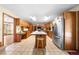 Large kitchen with tile floors, wood cabinets, and a center island with seating at 2471 Jenscot Rd, St Cloud, FL 34771