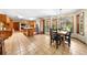 Open kitchen area with stainless steel appliances, wood cabinets, tile flooring, and breakfast table with natural lighting at 2471 Jenscot Rd, St Cloud, FL 34771