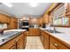 Kitchen with stainless steel appliances, wooden cabinets, and tile countertops at 2471 Jenscot Rd, St Cloud, FL 34771