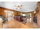 Well-lit living room with hardwood floors, brick fireplace, and access to other rooms at 2471 Jenscot Rd, St Cloud, FL 34771