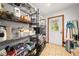 Pantry with metal shelves filled with an assortment of dry goods, and a back door for convenience at 2471 Jenscot Rd, St Cloud, FL 34771