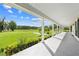 Covered back patio offers scenic views of the expansive backyard and landscape at 2471 Jenscot Rd, St Cloud, FL 34771