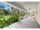 Covered patio features serene views of the lush green backyard and tropical foliage at 2471 Jenscot Rd, St Cloud, FL 34771