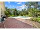 Backyard view of an in-ground pool with a brick patio, perfect for summer gatherings and outdoor entertaining at 2471 Jenscot Rd, St Cloud, FL 34771