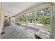 Bright porch overlooking the backyard boasts large windows, a ceiling fan, and a peaceful view of the pool area at 2471 Jenscot Rd, St Cloud, FL 34771