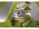 Aerial view showcases a home with a screened-in pool and a pond at 2503 Calla Lily Cv, Kissimmee, FL 34758