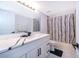 Modern bathroom with a stylish vanity, elegant fixtures, and a decorative shower curtain at 2503 Calla Lily Cv, Kissimmee, FL 34758