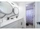 Renovated bathroom features dual sinks, modern fixtures, and a sleek marble accent wall at 2503 Calla Lily Cv, Kissimmee, FL 34758