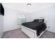 Comfortable bedroom features a bed with decorative pillows and blanket and a window with blinds at 2503 Calla Lily Cv, Kissimmee, FL 34758