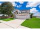 Charming two-story home with a well-manicured lawn and a two-car garage at 2503 Calla Lily Cv, Kissimmee, FL 34758