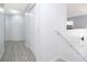 Bright hallway with tile flooring, leading to stairs and bedrooms, offering a clean, modern look at 2503 Calla Lily Cv, Kissimmee, FL 34758