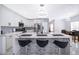 Modern kitchen with a large island, sleek black hardware, and modern pendant lighting at 2503 Calla Lily Cv, Kissimmee, FL 34758