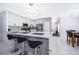 Open kitchen with a large island, seating, and stylish backsplash at 2503 Calla Lily Cv, Kissimmee, FL 34758