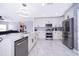 Modern kitchen featuring stainless appliances, a kitchen island, and sleek white cabinetry at 2503 Calla Lily Cv, Kissimmee, FL 34758