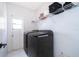 Bright laundry room featuring modern, front-load washer and dryer, with built-in shelving for storage at 2503 Calla Lily Cv, Kissimmee, FL 34758