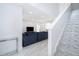 Stylish living room with modern staircase, marble floors, and comfortable blue seating at 2503 Calla Lily Cv, Kissimmee, FL 34758
