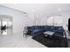 Bright living room with an open floor plan, comfortable sofa, and modern accents at 2503 Calla Lily Cv, Kissimmee, FL 34758