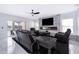 Modern living room featuring a stone fireplace, sleek black furniture, and marble floors at 2503 Calla Lily Cv, Kissimmee, FL 34758